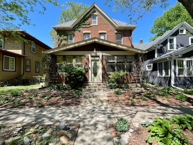 view of front facade featuring brick siding and entry steps