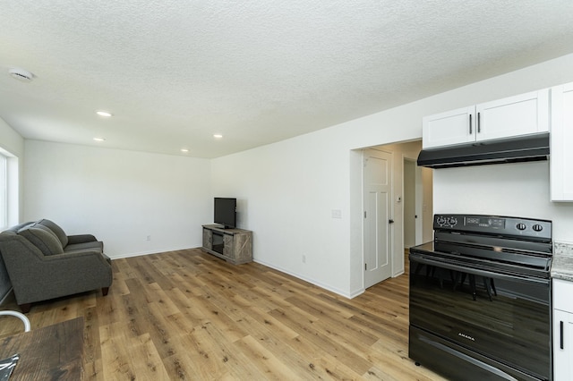unfurnished living room with light wood finished floors, recessed lighting, a textured ceiling, and baseboards