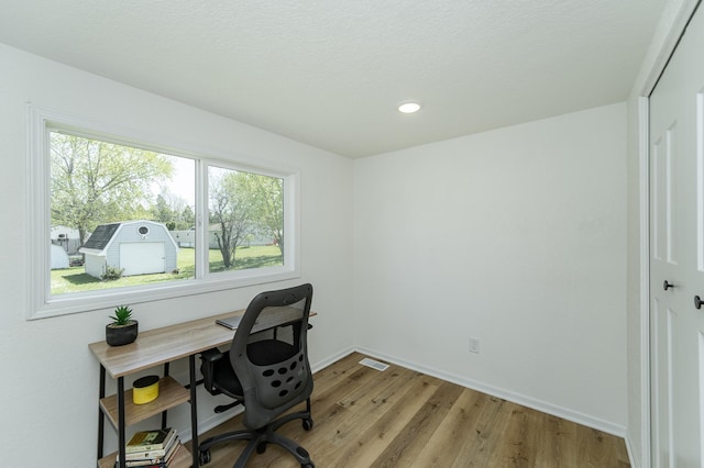 office area with light wood-style floors, baseboards, and recessed lighting