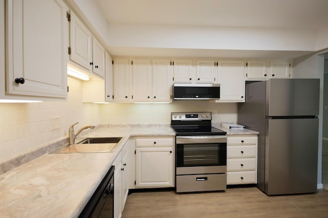 1345 Crestridge Ln Unit 203, Eagan, MN 55123 - kitchen with stainless steel appliances, light countertops, a sink, and light wood-style floors