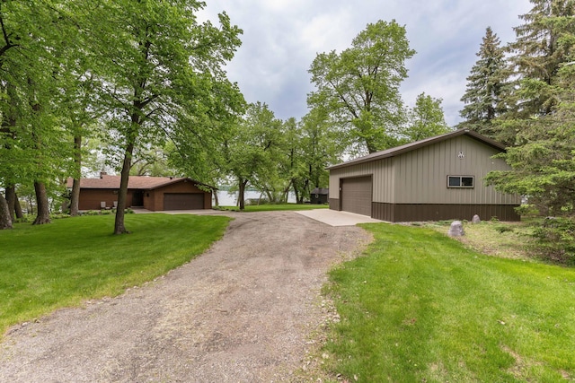 22005 Statesboro Trl, Clitherall, MN 56524 - view of front facade featuring a front lawn, a garage, and an outbuilding