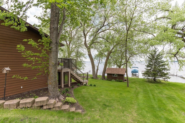 22005 Statesboro Trl, Clitherall, MN 56524 - view of green lawn with stairway, an outbuilding, and a deck with water view