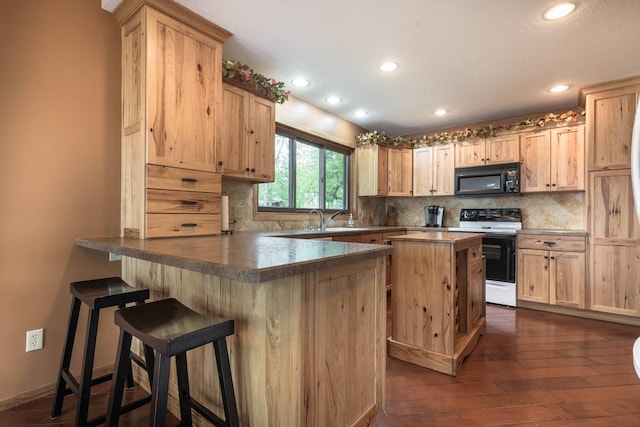 22005 Statesboro Trl, Clitherall, MN 56524 - kitchen with electric range oven, black microwave, light brown cabinetry, a peninsula, and backsplash