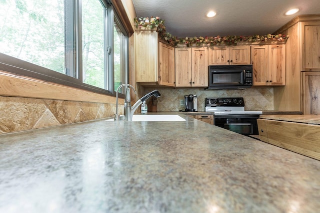22005 Statesboro Trl, Clitherall, MN 56524 - kitchen featuring black appliances, a sink, tasteful backsplash, and recessed lighting