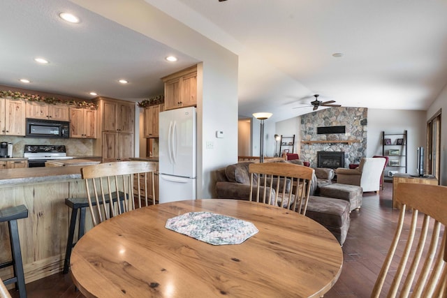 22005 Statesboro Trl, Clitherall, MN 56524 - dining room with a ceiling fan, dark wood finished floors, a stone fireplace, lofted ceiling, and recessed lighting