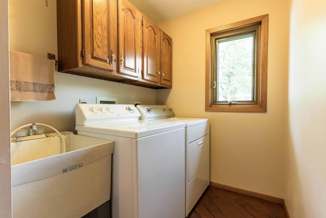 22005 Statesboro Trl, Clitherall, MN 56524 - laundry area with washer and clothes dryer, cabinet space, dark wood-style flooring, and baseboards