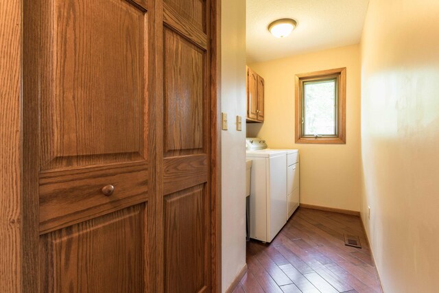 22005 Statesboro Trl, Clitherall, MN 56524 - washroom featuring cabinet space, washer and clothes dryer, wood-type flooring, and baseboards