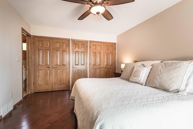 22005 Statesboro Trl, Clitherall, MN 56524 - bedroom featuring dark wood-style floors, baseboards, a ceiling fan, and two closets