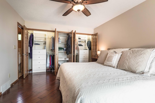 22005 Statesboro Trl, Clitherall, MN 56524 - bedroom with dark wood finished floors, baseboards, a ceiling fan, and a walk in closet