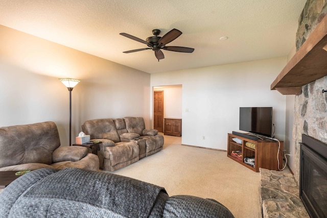 22005 Statesboro Trl, Clitherall, MN 56524 - living area featuring a stone fireplace, ceiling fan, and carpet