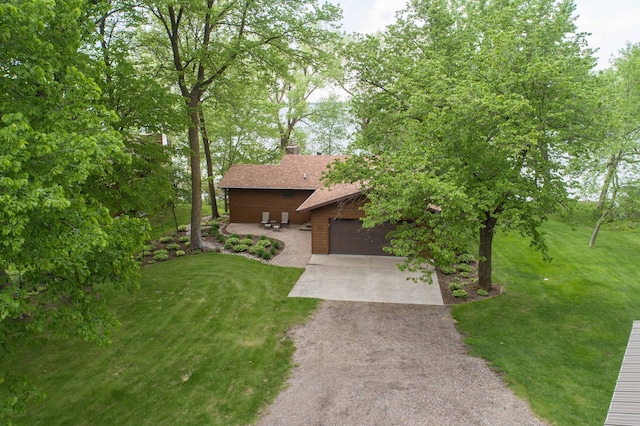 22005 Statesboro Trl, Clitherall, MN 56524 - view of front of home with a front lawn, asphalt driveway, an attached garage, and a chimney