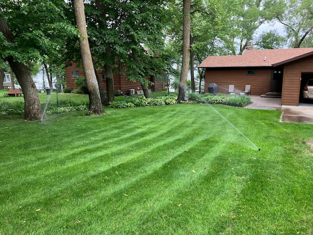 22005 Statesboro Trl, Clitherall, MN 56524 - view of green lawn with a patio