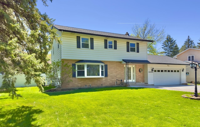 colonial home with brick siding, a garage, and concrete driveway