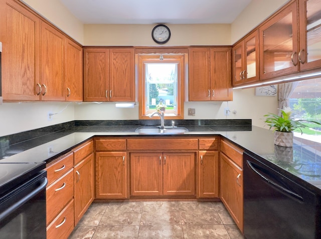 kitchen with black appliances, a sink, and brown cabinets