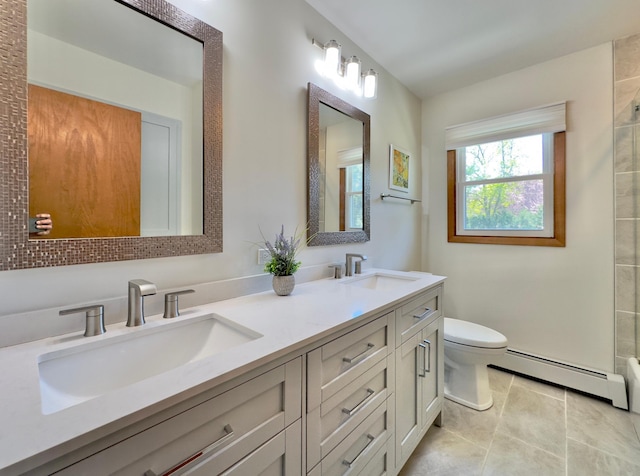 full bath with a baseboard radiator, toilet, tile patterned flooring, and double vanity
