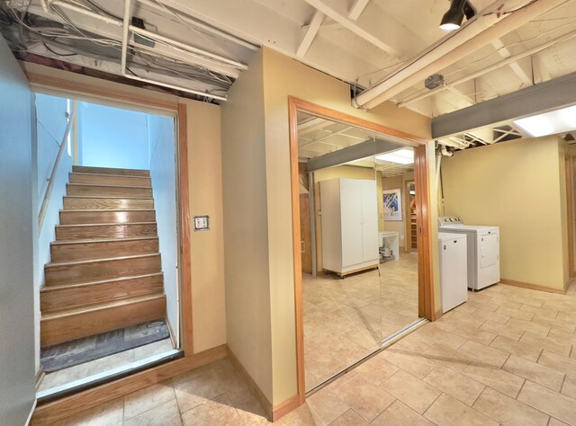 finished basement with independent washer and dryer, stairway, and baseboards