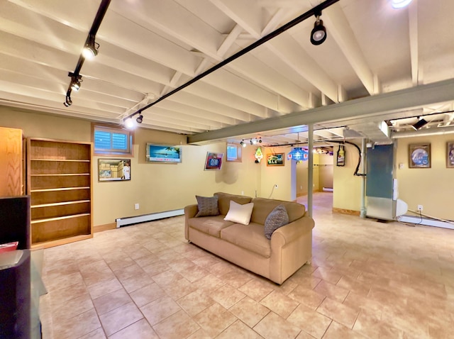 living room with rail lighting, baseboard heating, and baseboards
