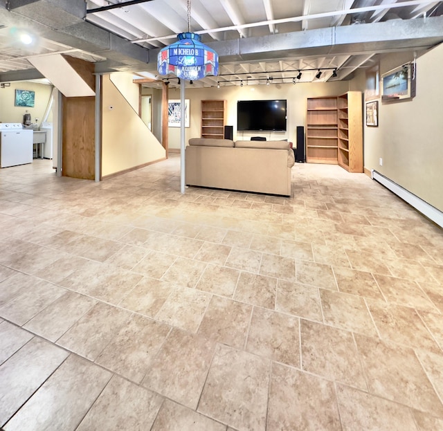 living area featuring washer / clothes dryer, baseboards, stairway, and baseboard heating