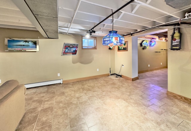 below grade area with a baseboard radiator and baseboards