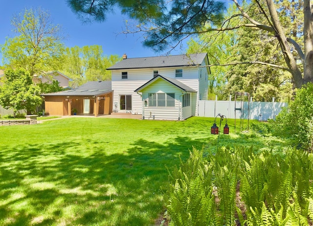 back of house featuring a chimney and a patio