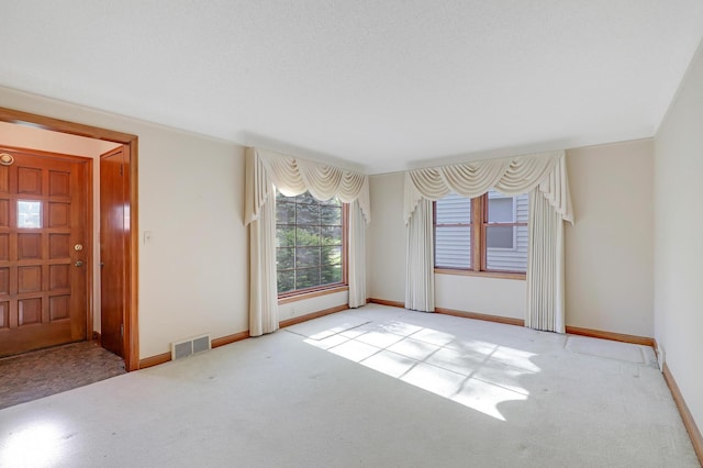 spare room featuring carpet flooring and baseboards