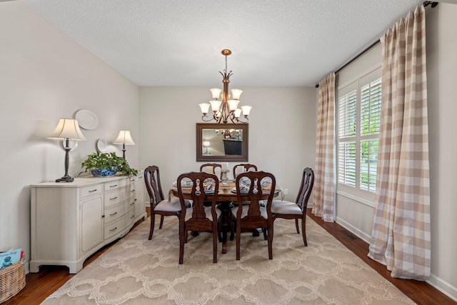 3121 Wild Flower Trl, Medina, MN 55340 - dining space featuring a chandelier, light wood-style floors, plenty of natural light, and a textured ceiling