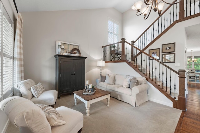 3121 Wild Flower Trl, Medina, MN 55340 - living area with a chandelier, stairs, wood finished floors, baseboards, and high vaulted ceiling