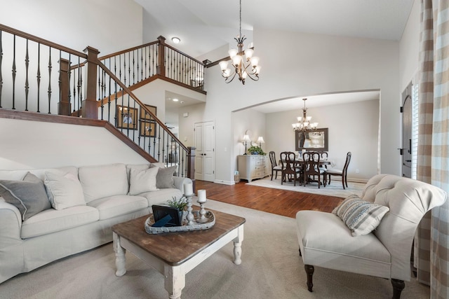 3121 Wild Flower Trl, Medina, MN 55340 - living room with a chandelier, wood finished floors, stairway, high vaulted ceiling, and baseboards