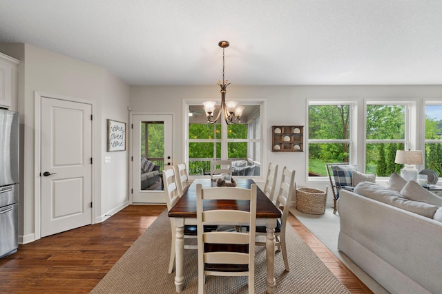 3121 Wild Flower Trl, Medina, MN 55340 - dining space with dark wood-style flooring, a chandelier, plenty of natural light, and baseboards
