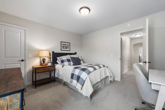 3121 Wild Flower Trl, Medina, MN 55340 - bedroom with arched walkways, light colored carpet, baseboards, and a textured ceiling