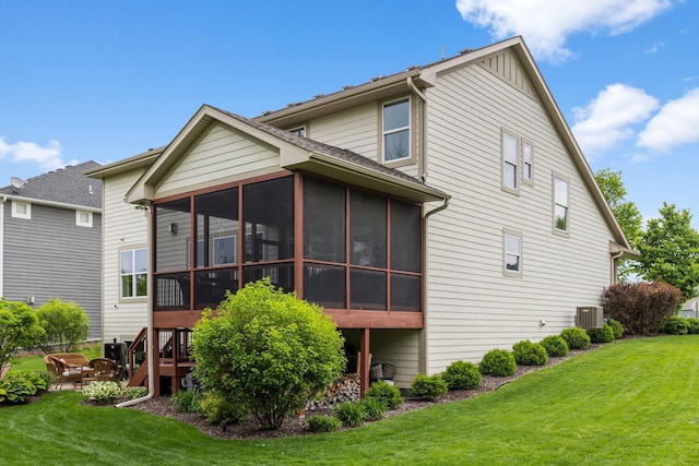 3121 Wild Flower Trl, Medina, MN 55340 - back of property with a sunroom, a lawn, and central AC
