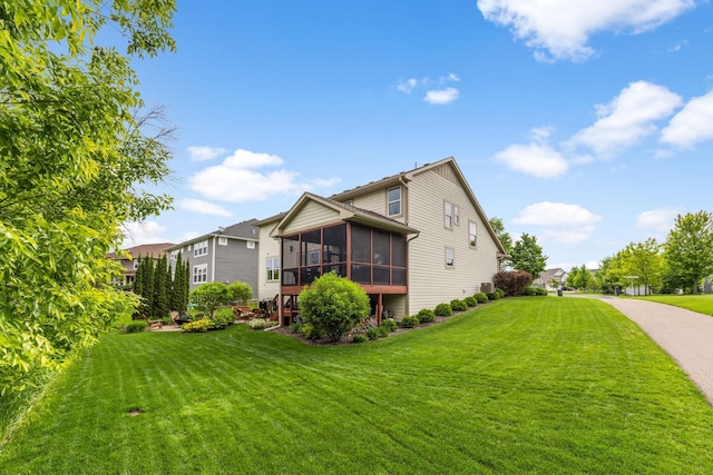 3121 Wild Flower Trl, Medina, MN 55340 - view of home's exterior featuring a sunroom and a yard