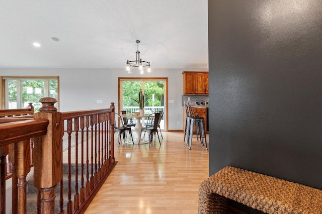 2820 Wilderness Ridge Rd SE, Alexandria, MN 56308 - hallway with light wood finished floors, a chandelier, and recessed lighting