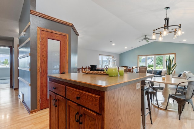 2820 Wilderness Ridge Rd SE, Alexandria, MN 56308 - kitchen with open floor plan, a kitchen breakfast bar, lofted ceiling, light wood-style floors, and healthy amount of natural light