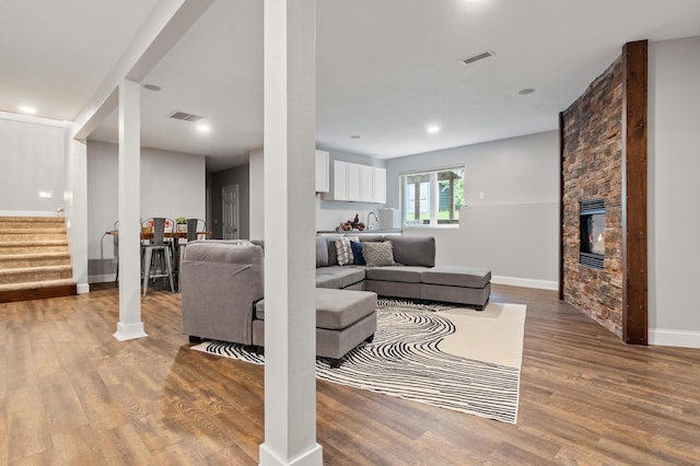2820 Wilderness Ridge Rd SE, Alexandria, MN 56308 - living area featuring stairs, wood finished floors, a fireplace, and recessed lighting
