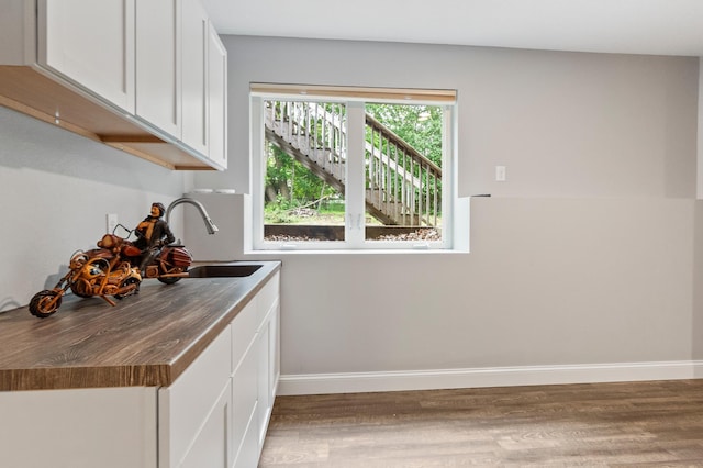 2820 Wilderness Ridge Rd SE, Alexandria, MN 56308 - kitchen featuring light wood finished floors and white cabinetry