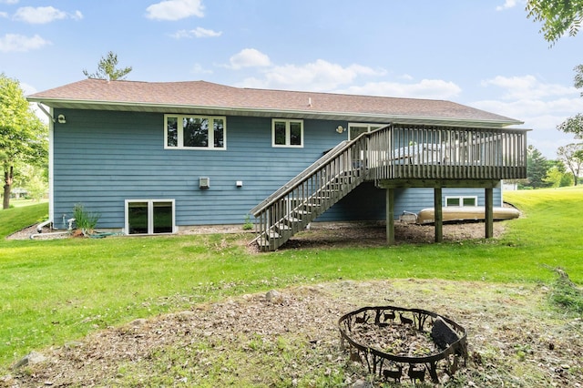 2820 Wilderness Ridge Rd SE, Alexandria, MN 56308 - rear view of property featuring stairway, a wooden deck, a lawn, and a fire pit