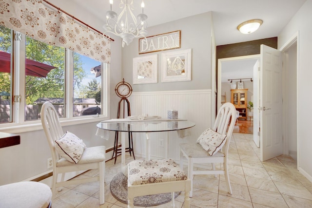 dining space featuring a chandelier and wainscoting