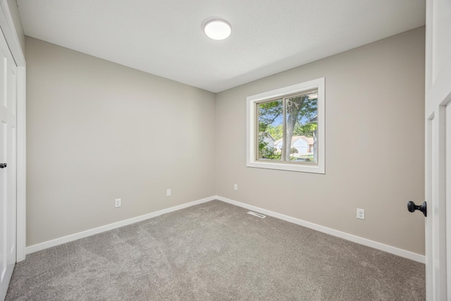 unfurnished bedroom featuring carpet floors and baseboards