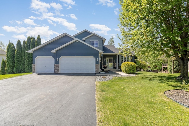 6609 210th Ln N, Forest Lake, MN 55025 - view of front of property with driveway, an attached garage, a front yard, and stone siding