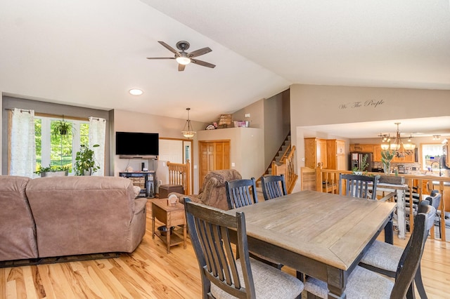6609 210th Ln N, Forest Lake, MN 55025 - dining space featuring vaulted ceiling, stairs, light wood-type flooring, ceiling fan, and a chandelier