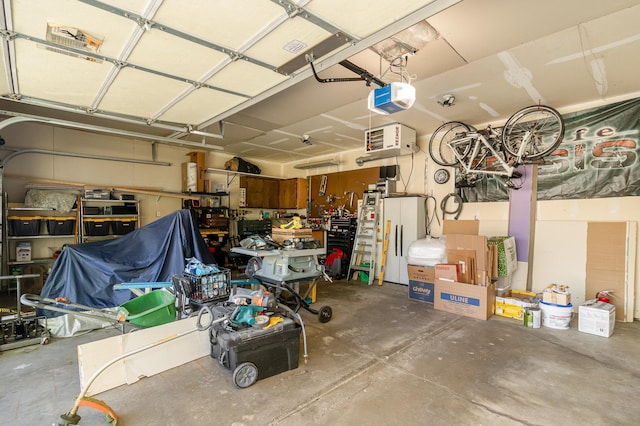 6609 210th Ln N, Forest Lake, MN 55025 - garage featuring a garage door opener, a heating unit, and a workshop area