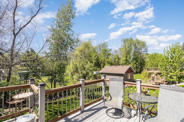 6609 210th Ln N, Forest Lake, MN 55025 - wooden terrace with an outbuilding and view of wooded area