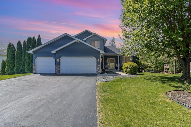 6609 210th Ln N, Forest Lake, MN 55025 - view of front of property featuring driveway, an attached garage, a front lawn, and stone siding