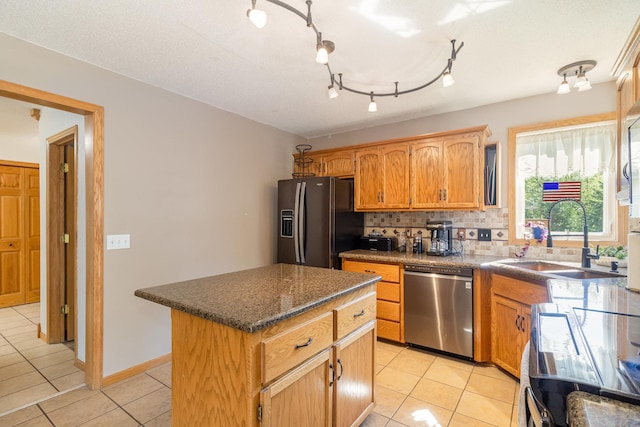 6609 210th Ln N, Forest Lake, MN 55025 - kitchen with dishwasher, refrigerator with ice dispenser, light tile patterned floors, a kitchen island, and decorative backsplash