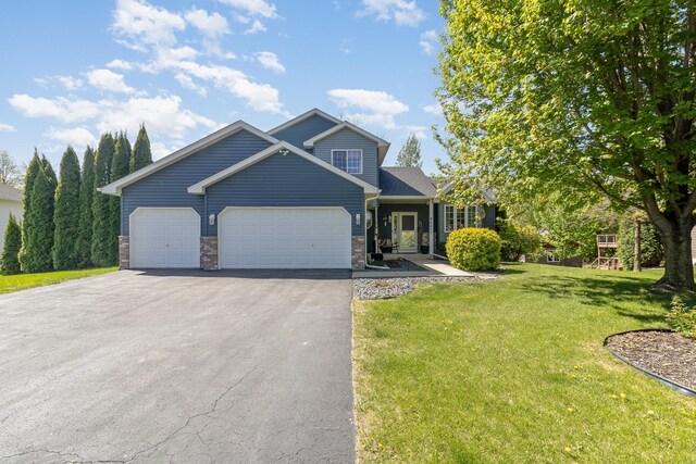 6609 210th Ln N, Forest Lake, MN 55025 - view of front of home featuring asphalt driveway, an attached garage, a front lawn, and stone siding