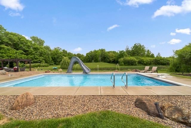 18565 Revere Ave, Spring Lake Twp, MN 55372 - swimming pool featuring a water slide, a diving board, a pergola, and view of wooded area