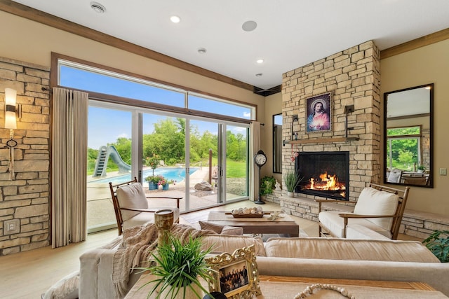 18565 Revere Ave, Spring Lake Twp, MN 55372 - living area with a stone fireplace, wood finished floors, and plenty of natural light