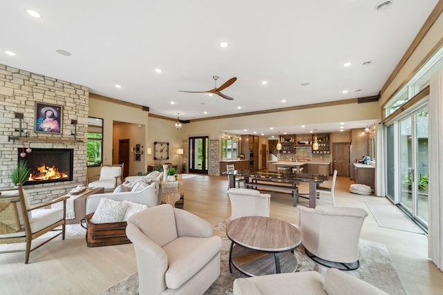 18565 Revere Ave, Spring Lake Twp, MN 55372 - living room featuring ornamental molding, ceiling fan, a fireplace, light wood-type flooring, and recessed lighting
