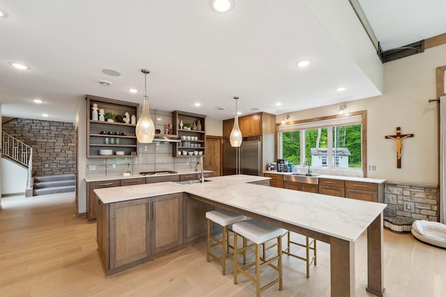 18565 Revere Ave, Spring Lake Twp, MN 55372 - kitchen with open shelves, a sink, high end fridge, light wood-style floors, and recessed lighting